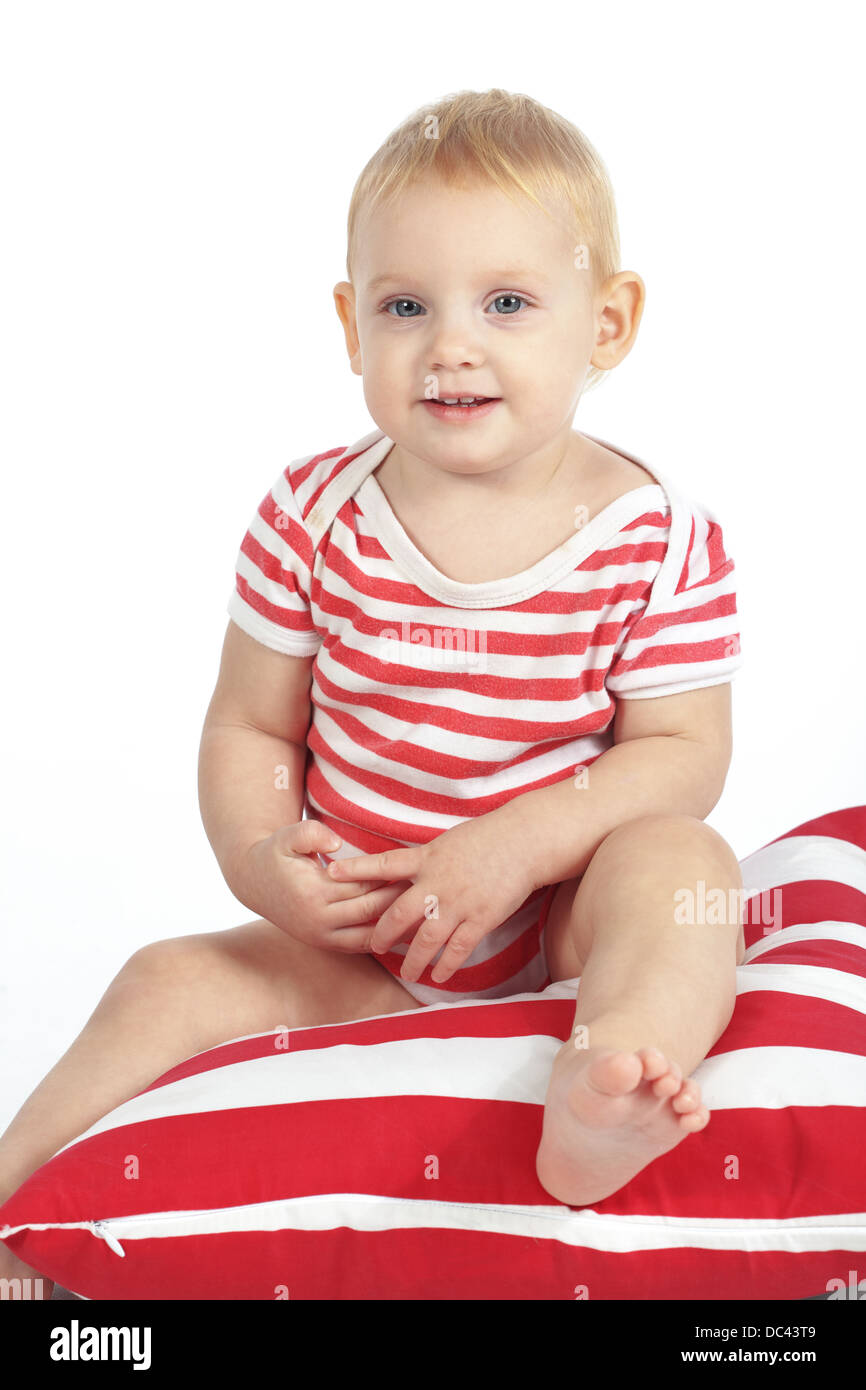 Child sitting on pillow Stock Photo Alamy