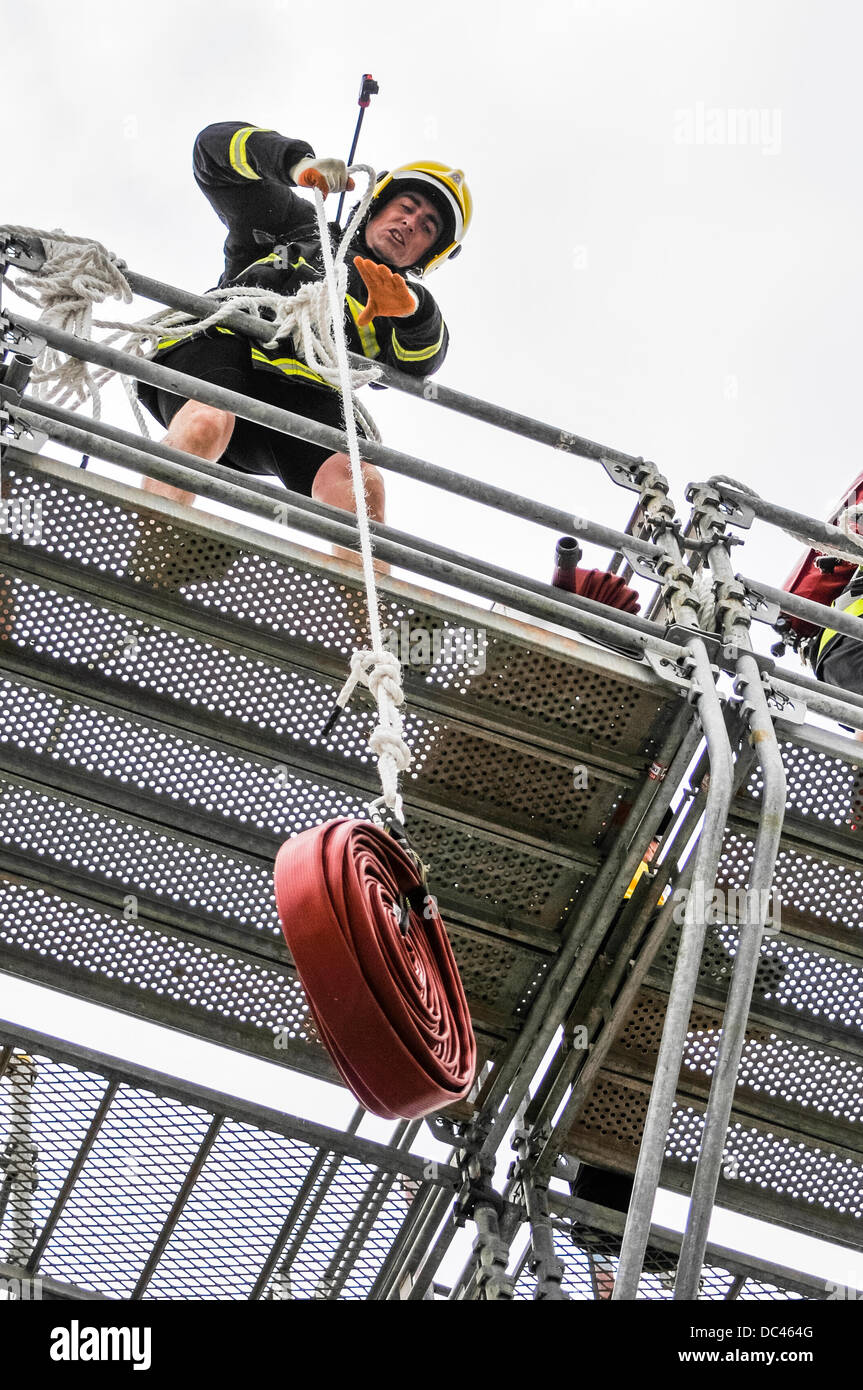 Belfast, Northern Ireland. 8th August 2013 - A fireman pulls a hosepipe 100ft onto a gantry at the Ultimate Firefighter Event, World Police and Fire Games (WPFG) Credit:  Stephen Barnes/Alamy Live News Stock Photo