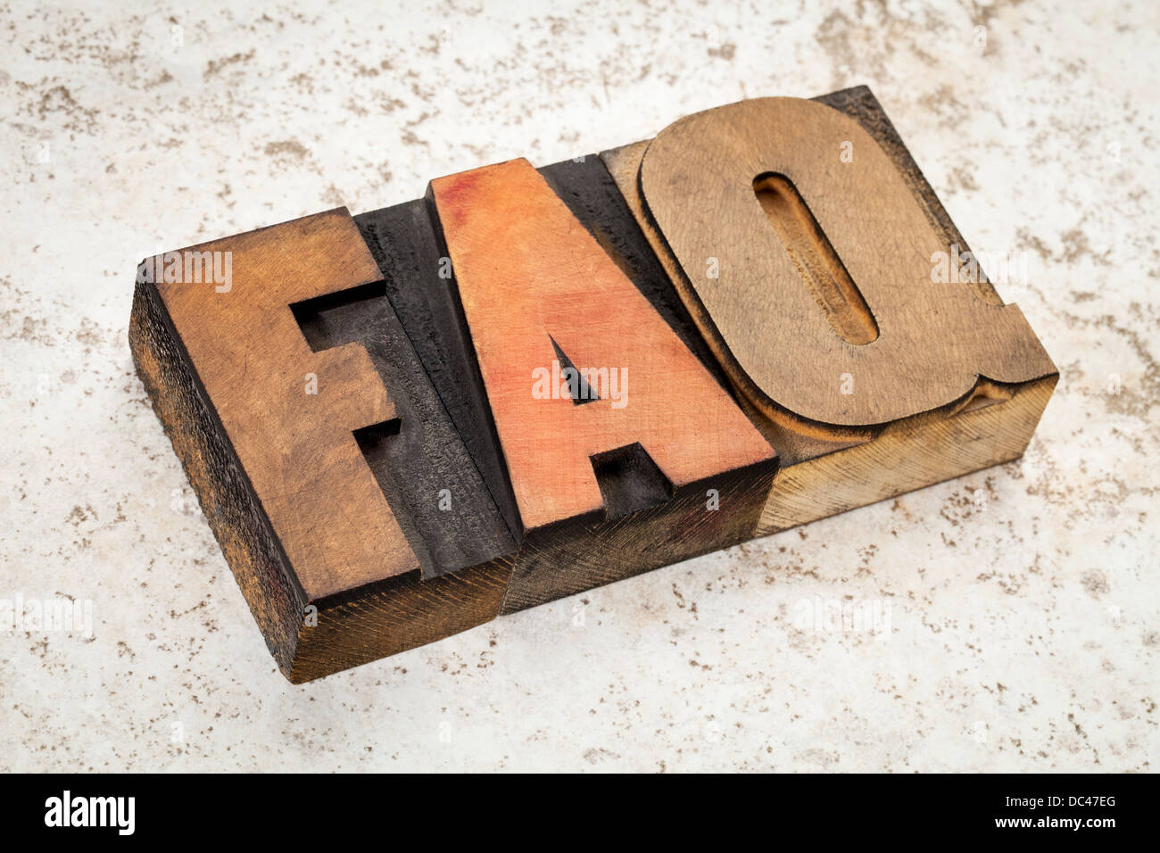 frequently asked questions - FAQ acronym - text in vintage letterpress wood type on a ceramic tile background Stock Photo