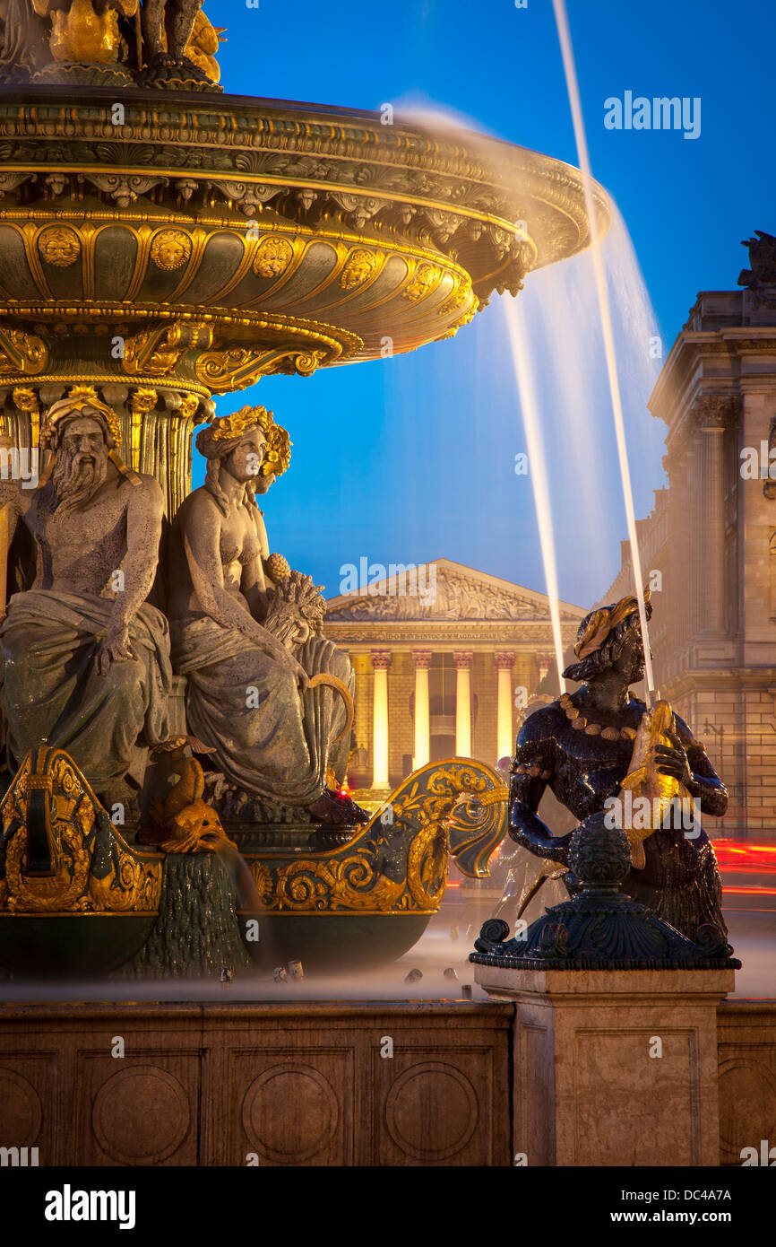 Fontaine des Fleuves - Fountain of Rivers at Place de la Concorde with L'église Sainte-Marie-Madeleine beyond, Paris France Stock Photo