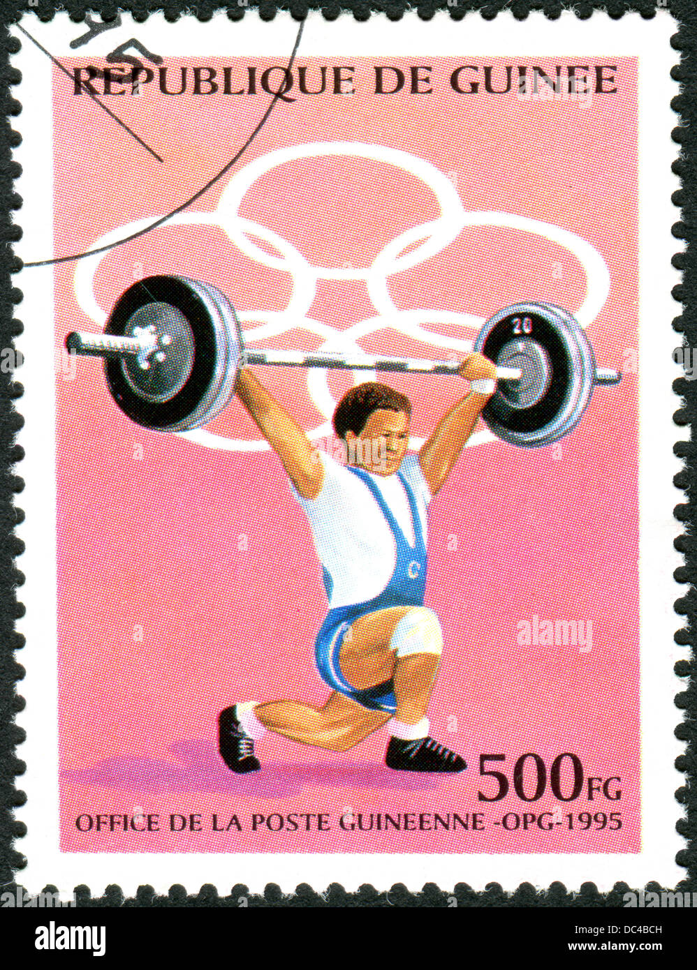 GUINEA - CIRCA 1995: A stamp printed in Guinea, devoted Summer Olympic Games in Atlanta, shows weightlifter, circa 1995 Stock Photo