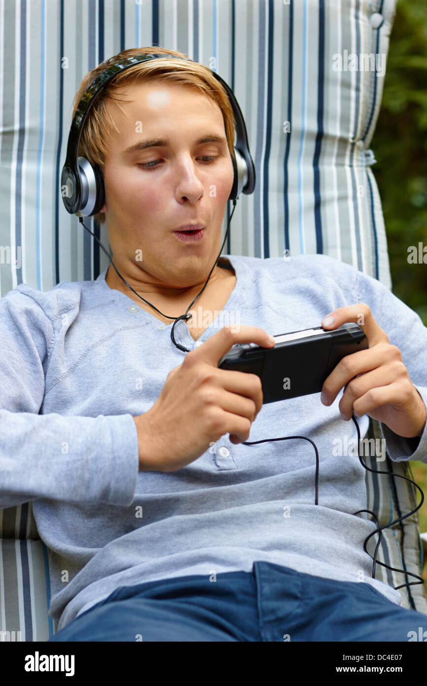 Young male having fun on game console Stock Photo