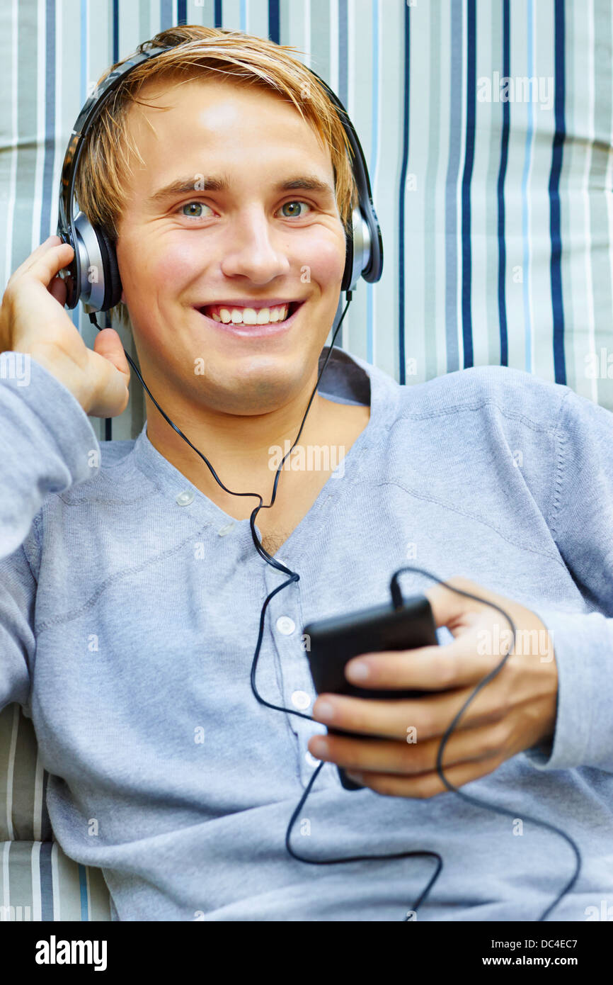 Teenager relaxing and listening to tunes. Stock Photo