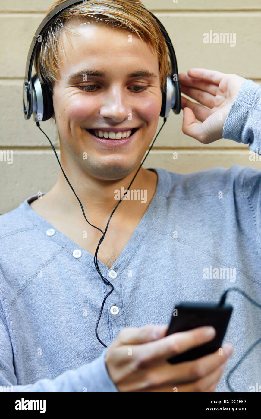 Young male listening to music on portable player Stock Photo