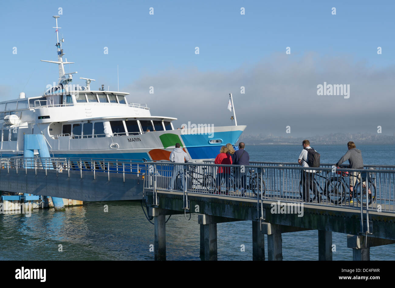 Passengers with bikes boarding ferry to SF, Sausalito, CA Stock Photo
