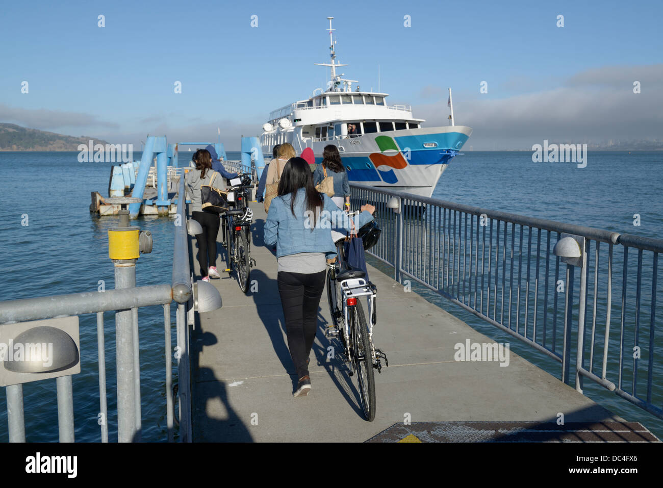 Passengers with bikes boarding ferry to SF, Sausalito, CA Stock Photo