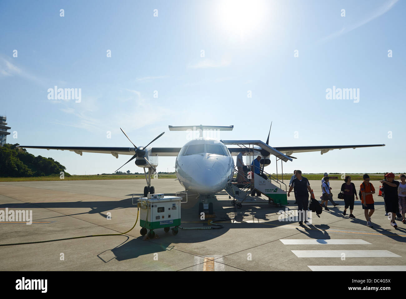 Tourists disembarking a small propeller plane at Matsu Beigan Airport Stock Photo