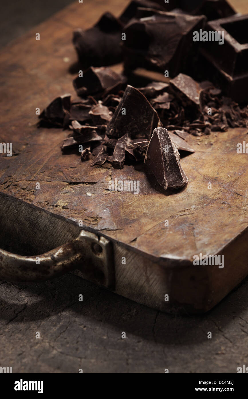 Pieces of dark chocolate  on a wooden background Stock Photo
