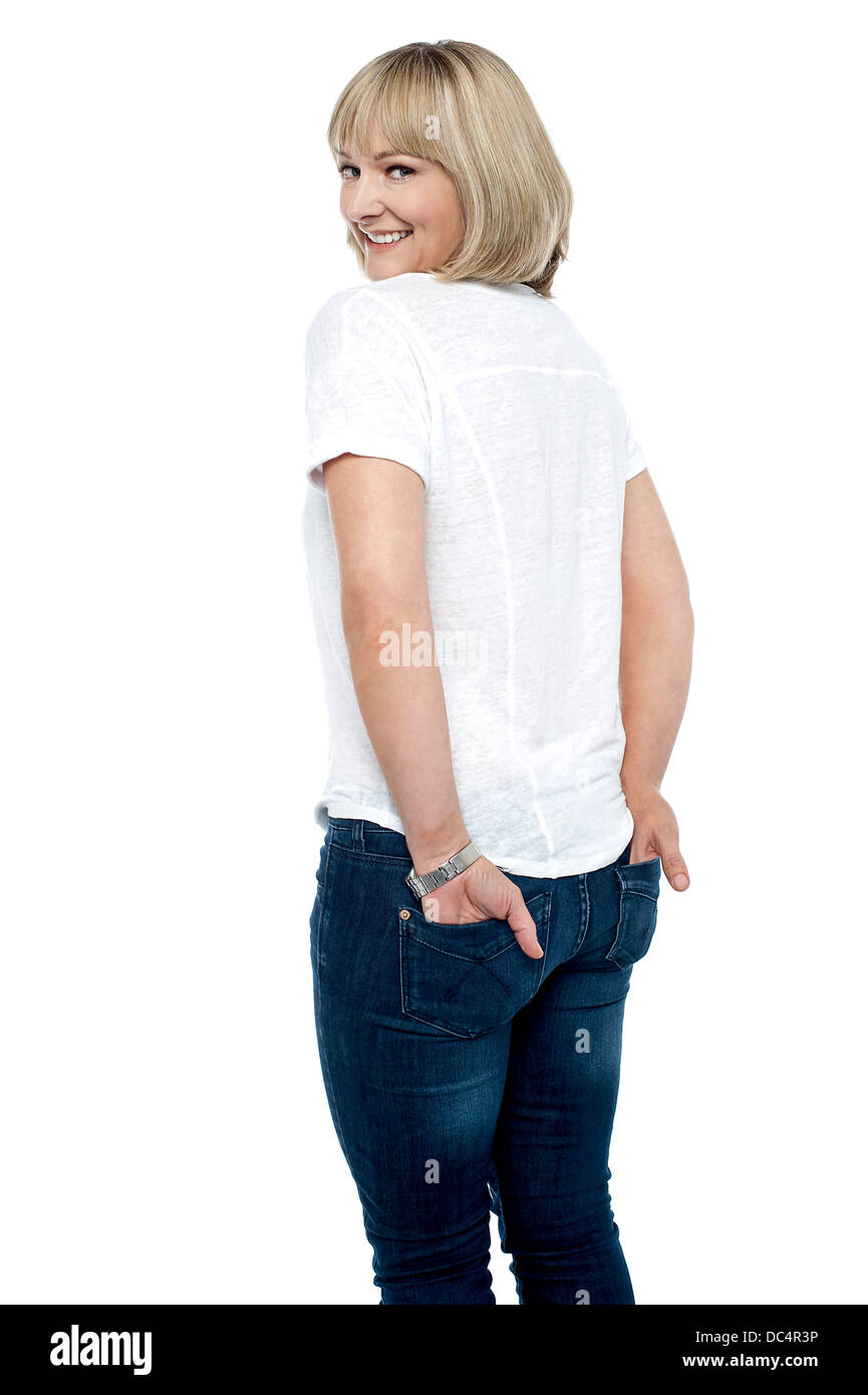 Smartly dressed woman with hands in back pocket of jeans Stock Photo ...