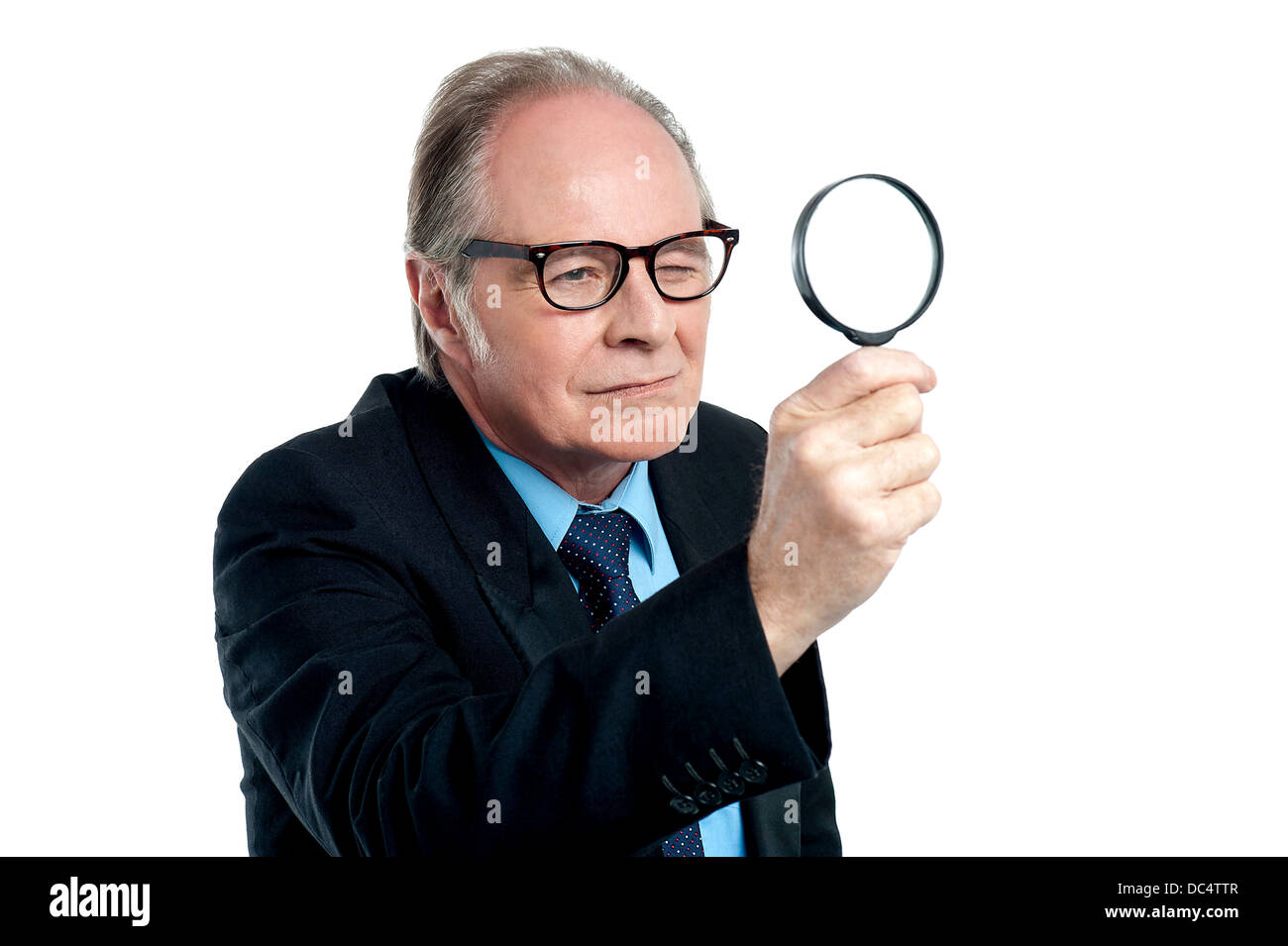 Detective exploring through a magnifying glass Stock Photo - Alamy