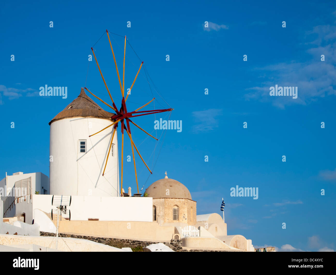 Traditional Windmills and white buildings at Oia Santorini Greece Stock Photo