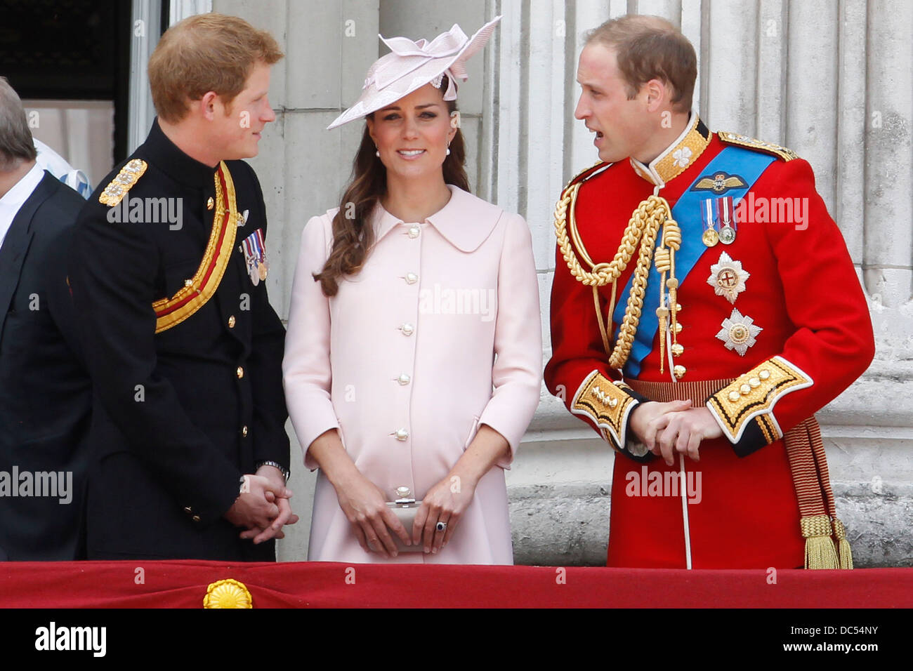 (L-R) Prince Harry, Catherine, Duchess of Cambridge and Prince William, Duke of Cambridge stand on the balcony of Buckingham Pal Stock Photo