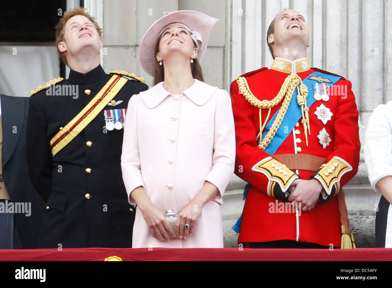 (L-R) Prince Harry, Catherine, Duchess of Cambridge and Prince William, Duke of Cambridge stand on the balcony of Buckingham Pal Stock Photo