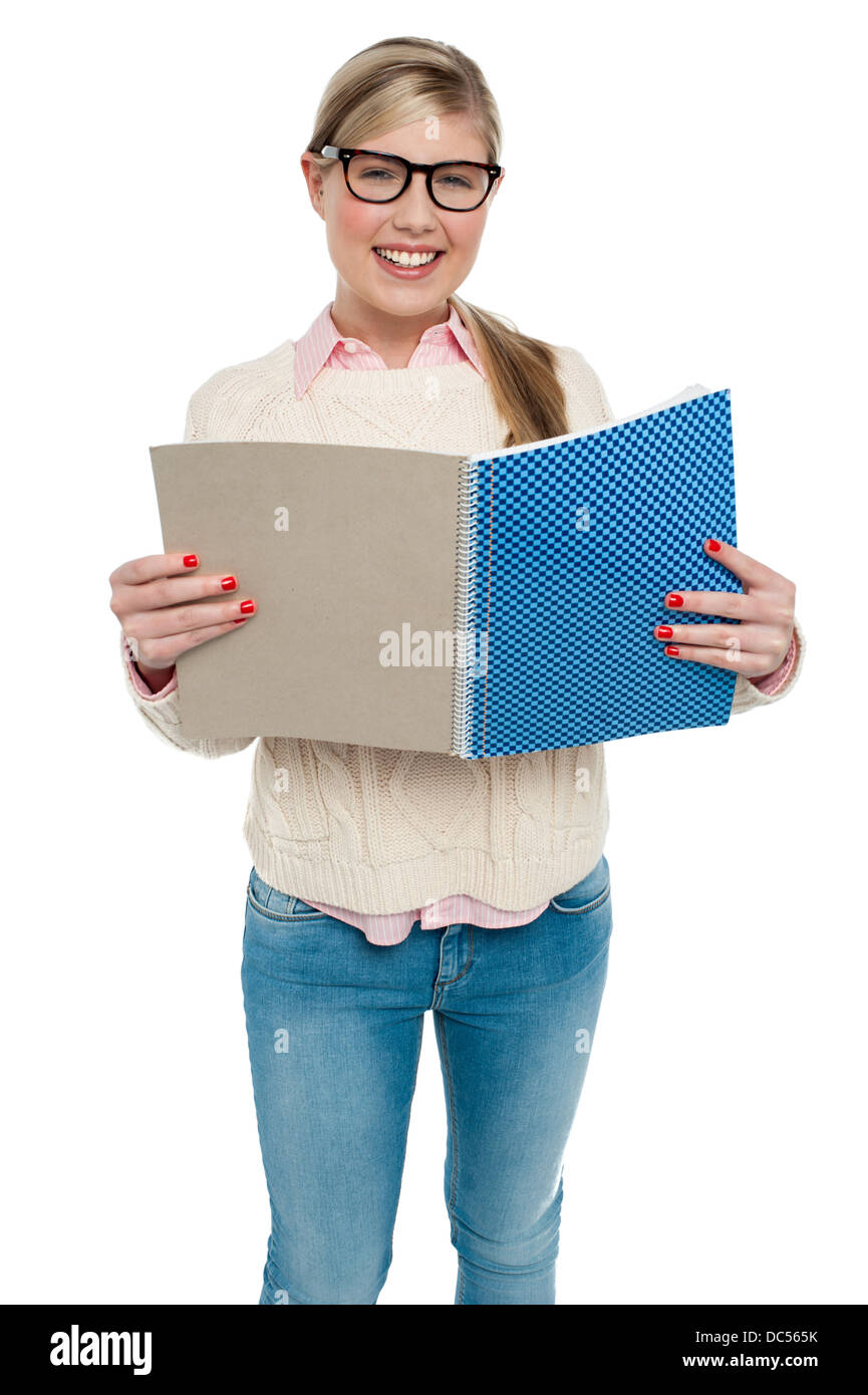 Smiling student reading from her note book Stock Photo - Alamy