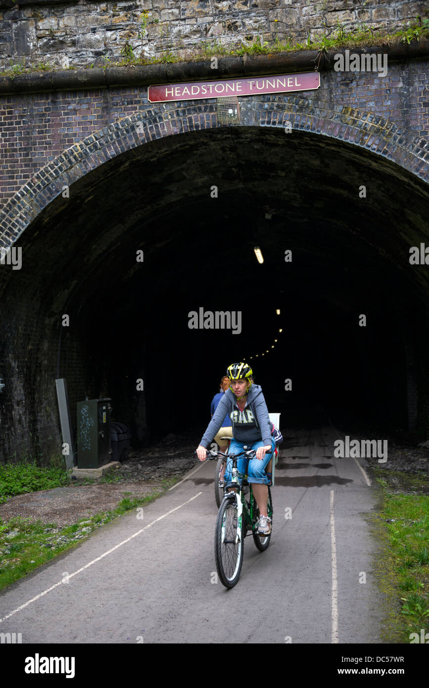 Cyclists emerging from Headstone Tunnel, Monsal Trail, Derbyshire Stock Photo