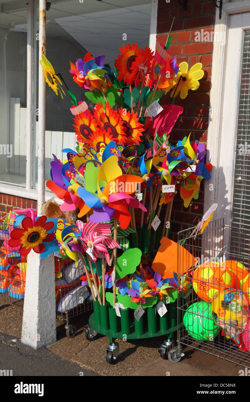 Colourful display of toy windmills at seaside beach shop in Dymchurch