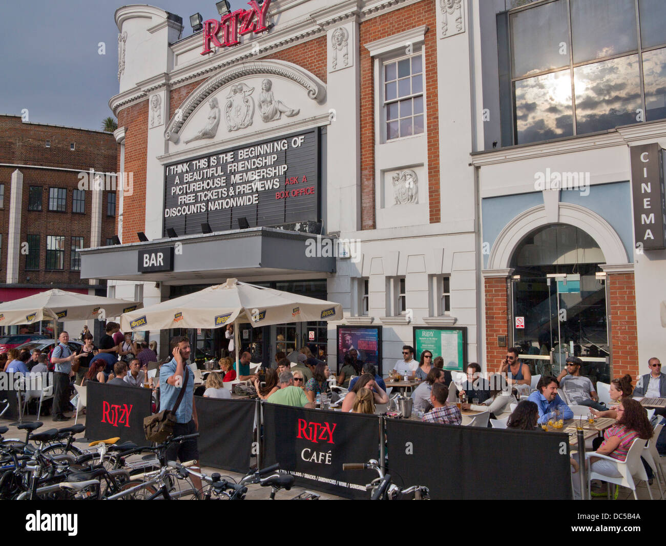 UK. PEOPLE DRINK AT THE BAR OUTSIDE THE ART DECO RITZY CINEMA IN BRIXTON, LONDON Stock Photo