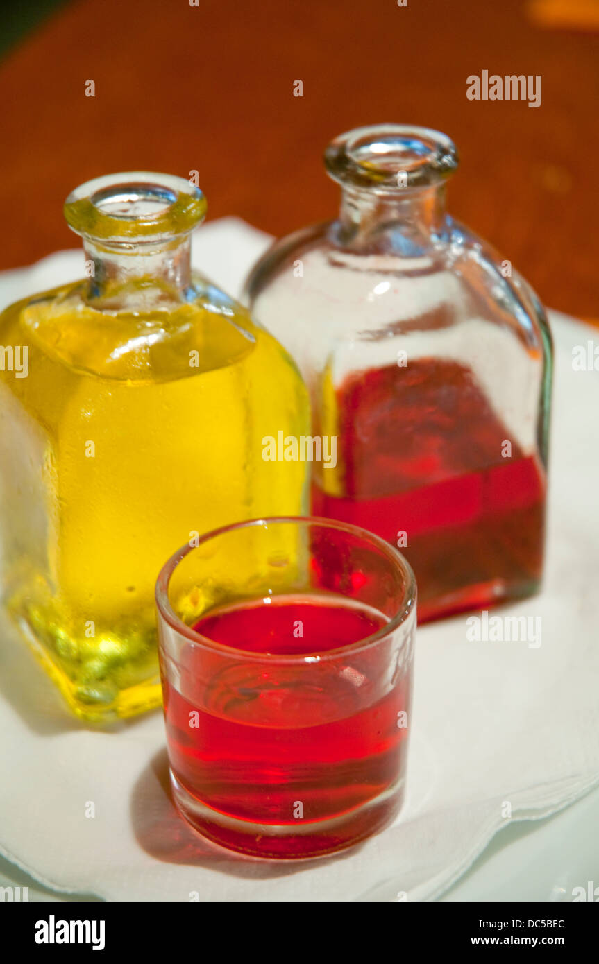 Two bottles and a glass of liqueur. Close view. Stock Photo