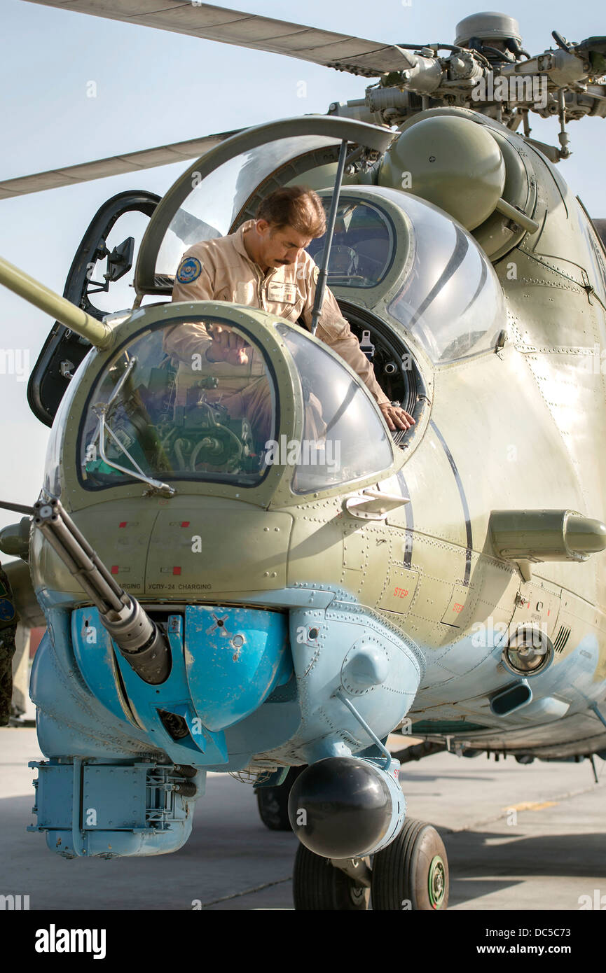 Afghan air force aerial gunner Mohamad Asif climbs out of an Mi-35 attack helicopter after arriving July 22, 2013 at Jalalabad Airfield, Afghanistan. Stock Photo