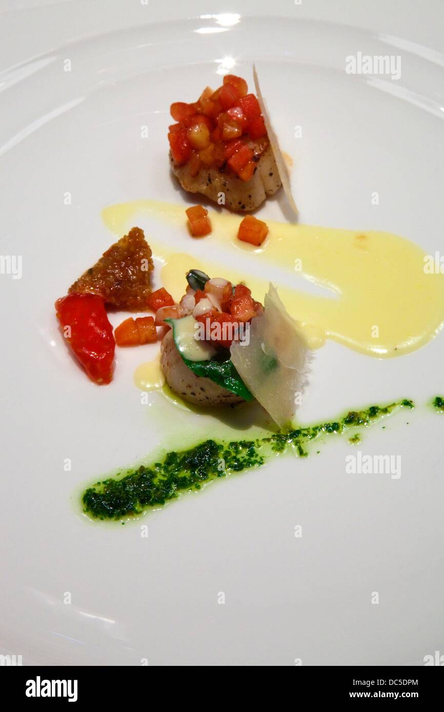 Scallops a la plancha Refreshing leaves, sweet garlic cream and smooth