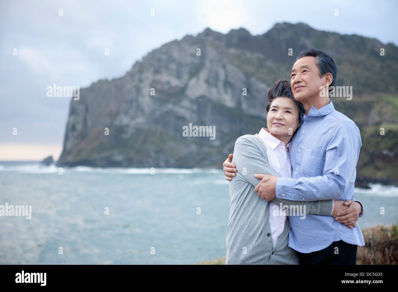 Middle aged asian couple hugging and smiling hi-res stock photography ...