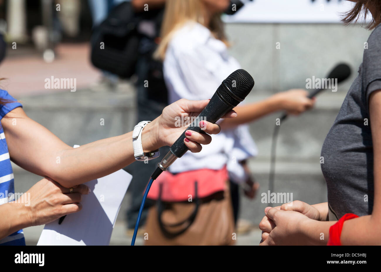 A journalist is making a interview with a microphone Stock Photo - Alamy