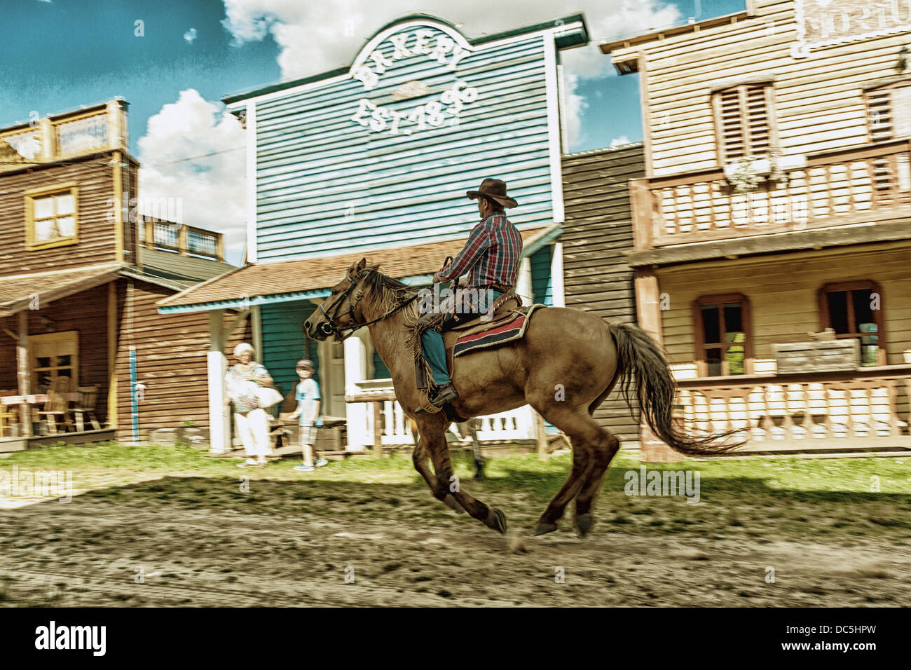Cowboy riding horse in the Western City - Kraina Westernu - in Sarnowa Gora, Poland Stock Photo
