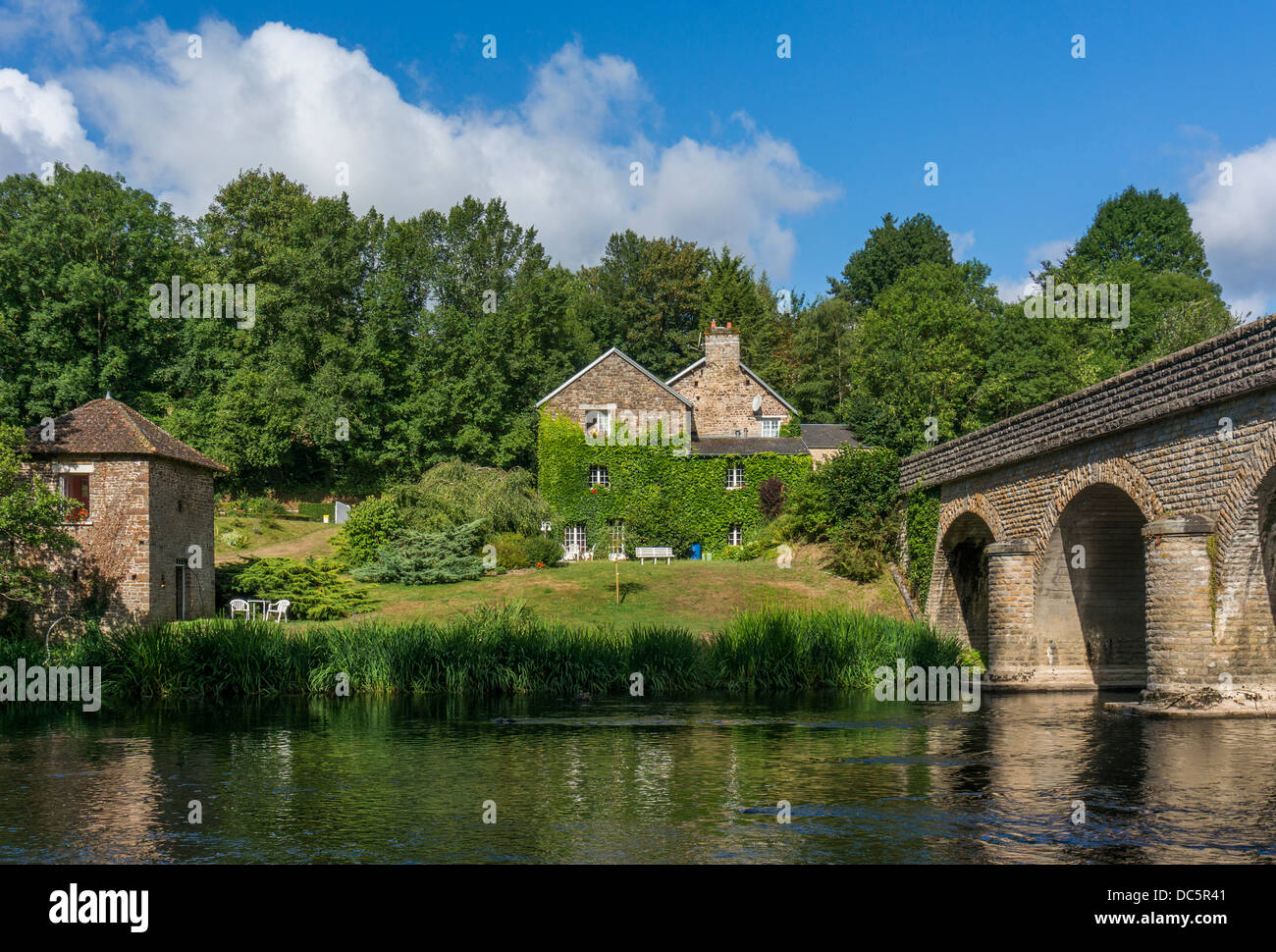 Chambre d'hotes, gite and bridge over the river at Le Vey, near Clécy, Calvados department, Basse-Normandie, north west France. Stock Photo