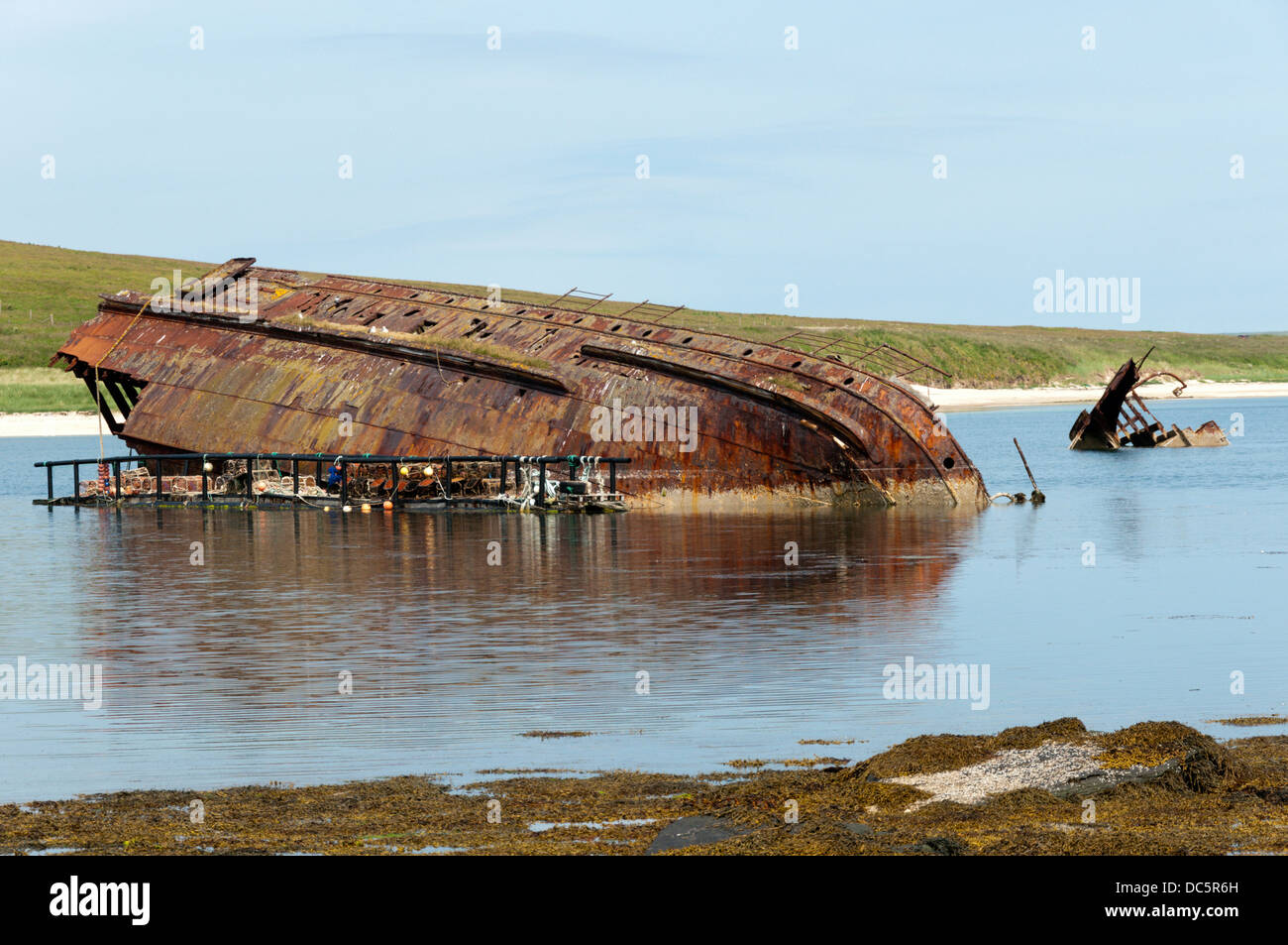 Remains of a blockship in eastern Weddell Sound next to Churchill Barrier 3 between Glimps Holm and Burray, Orkney. Stock Photo