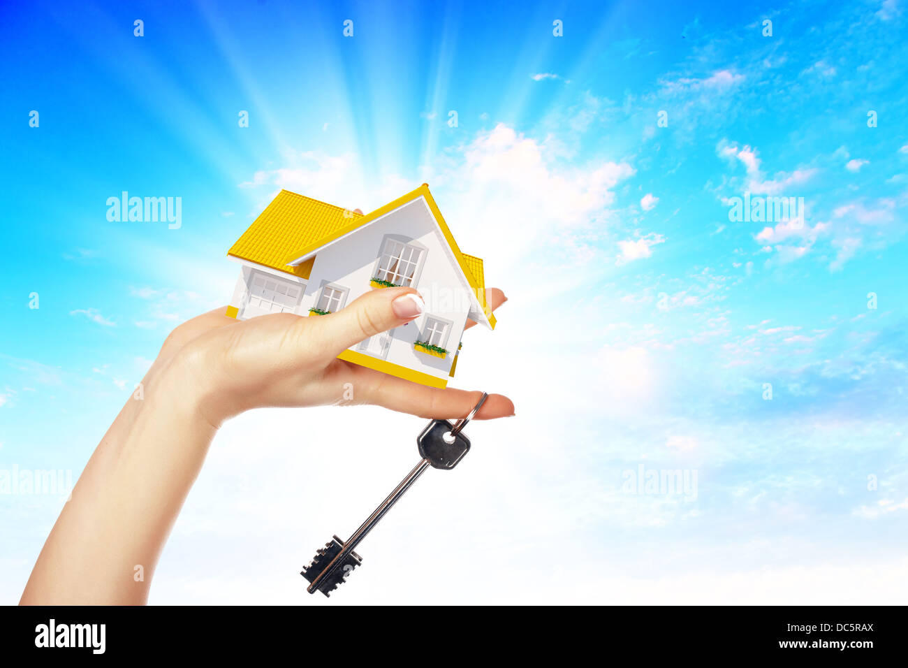 the house in hands on blue sky Stock Photo - Alamy