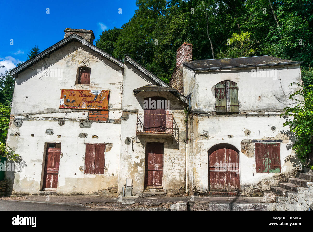 Derelict shop buildings at Le Vey, near Clécy, Calvados department, Basse-Normandie, north west France. Stock Photo