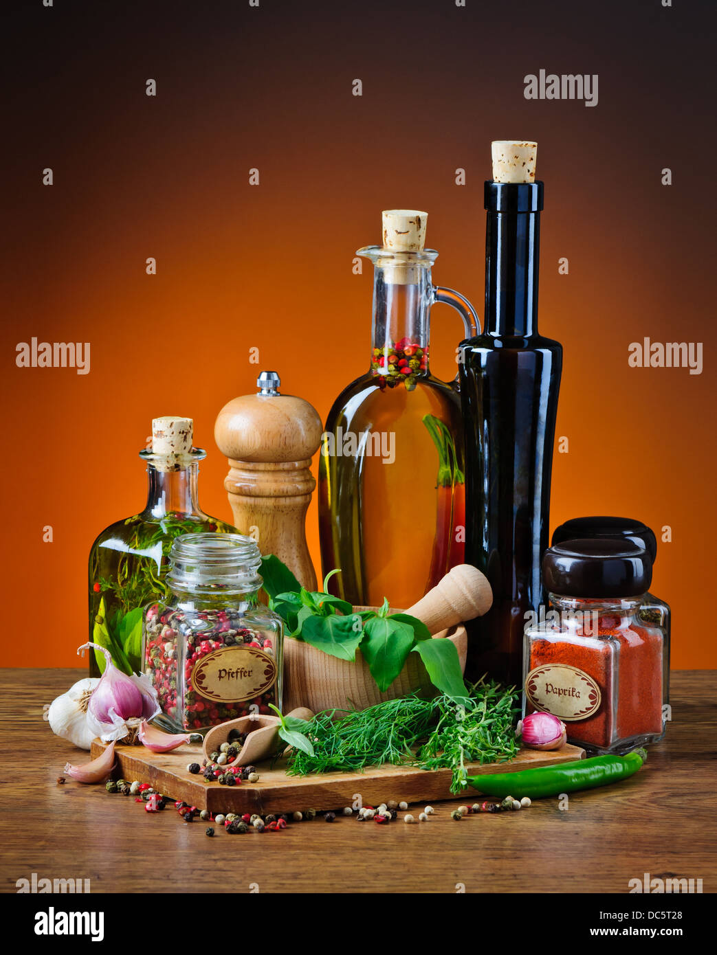 still life with infused olive oil, herbs and various spices Stock Photo