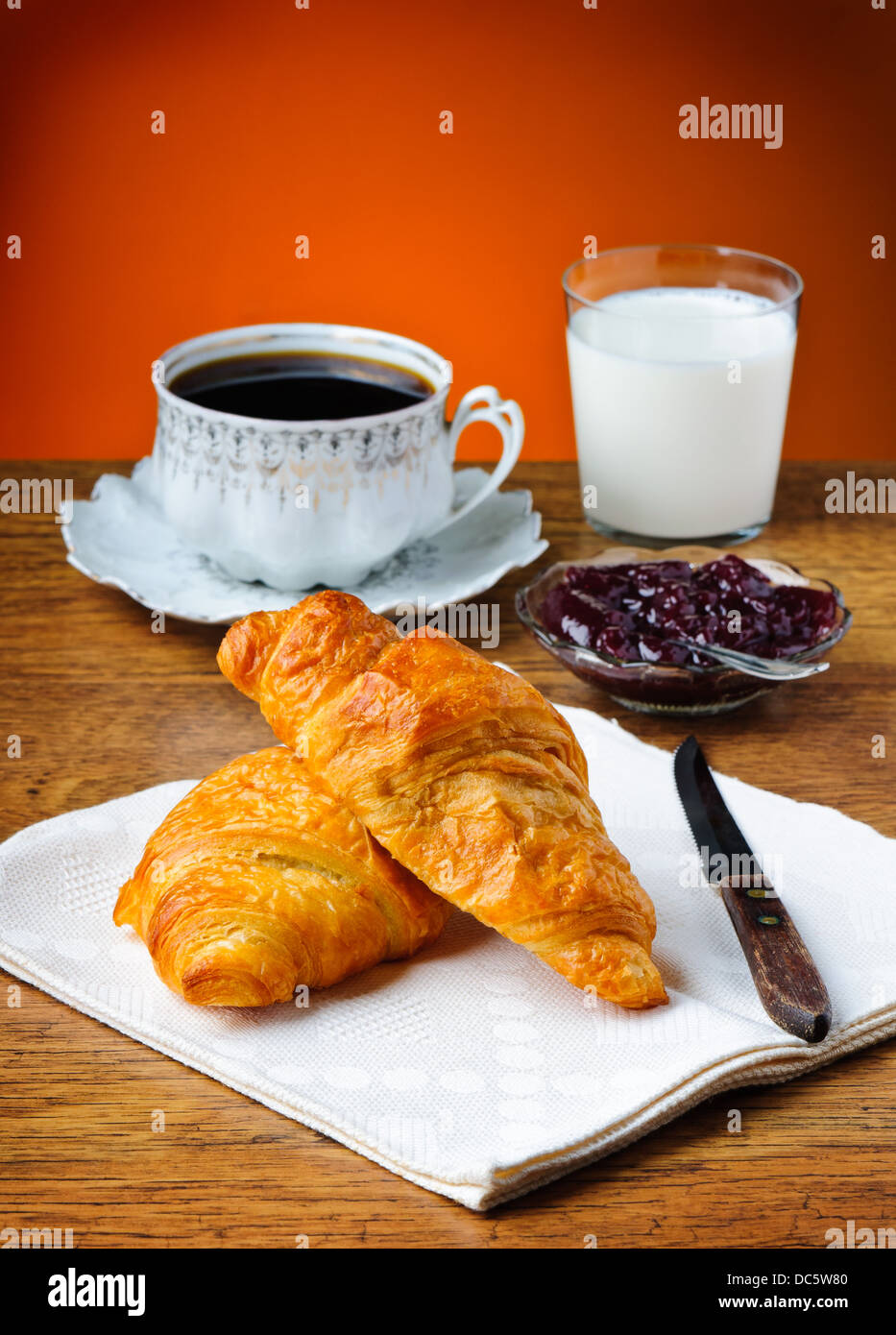 still life with french breakfast, croissant, marmalade, milk and coffee ...