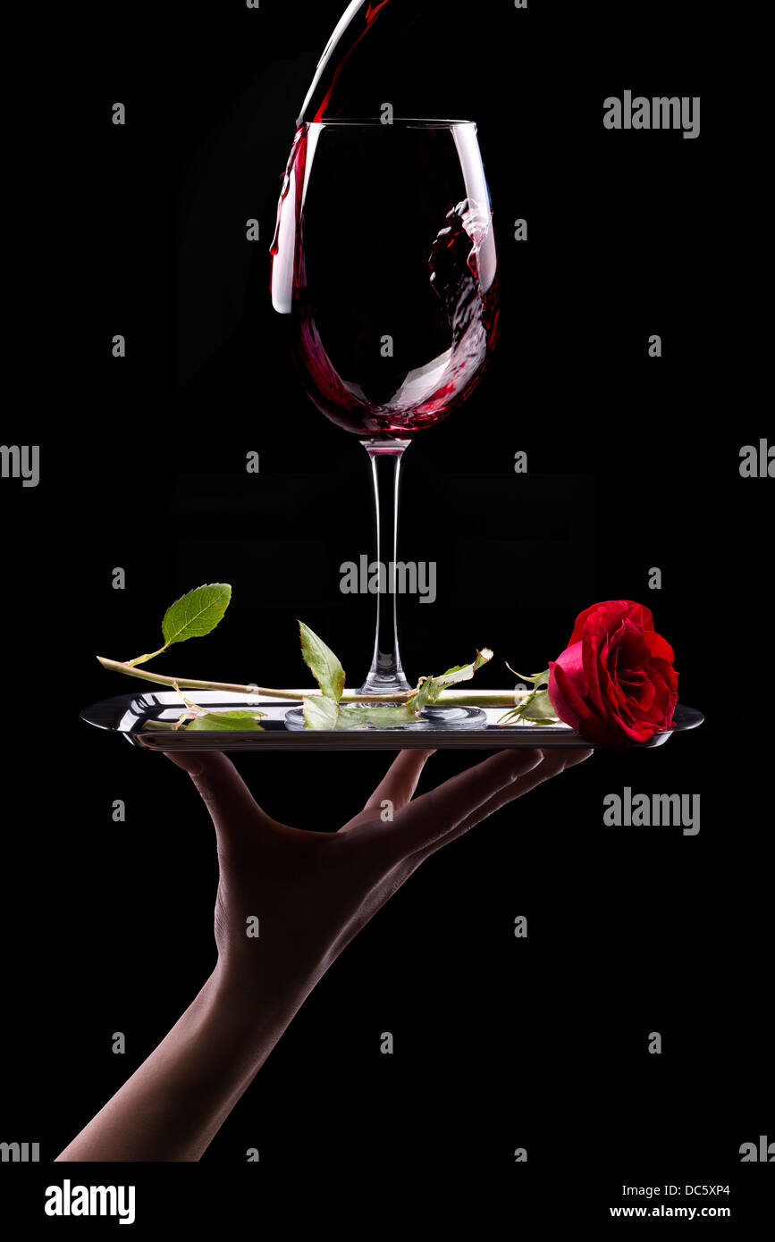 glass of red wine and red rose on black background Stock Photo - Alamy