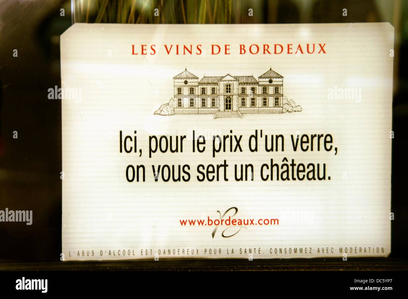 Wines of Bordeaux: ´Her for the price of a glass, you get a castle´ promo sign for the Bordeaux wines in a bar, at Bordeaux, Stock Photo
