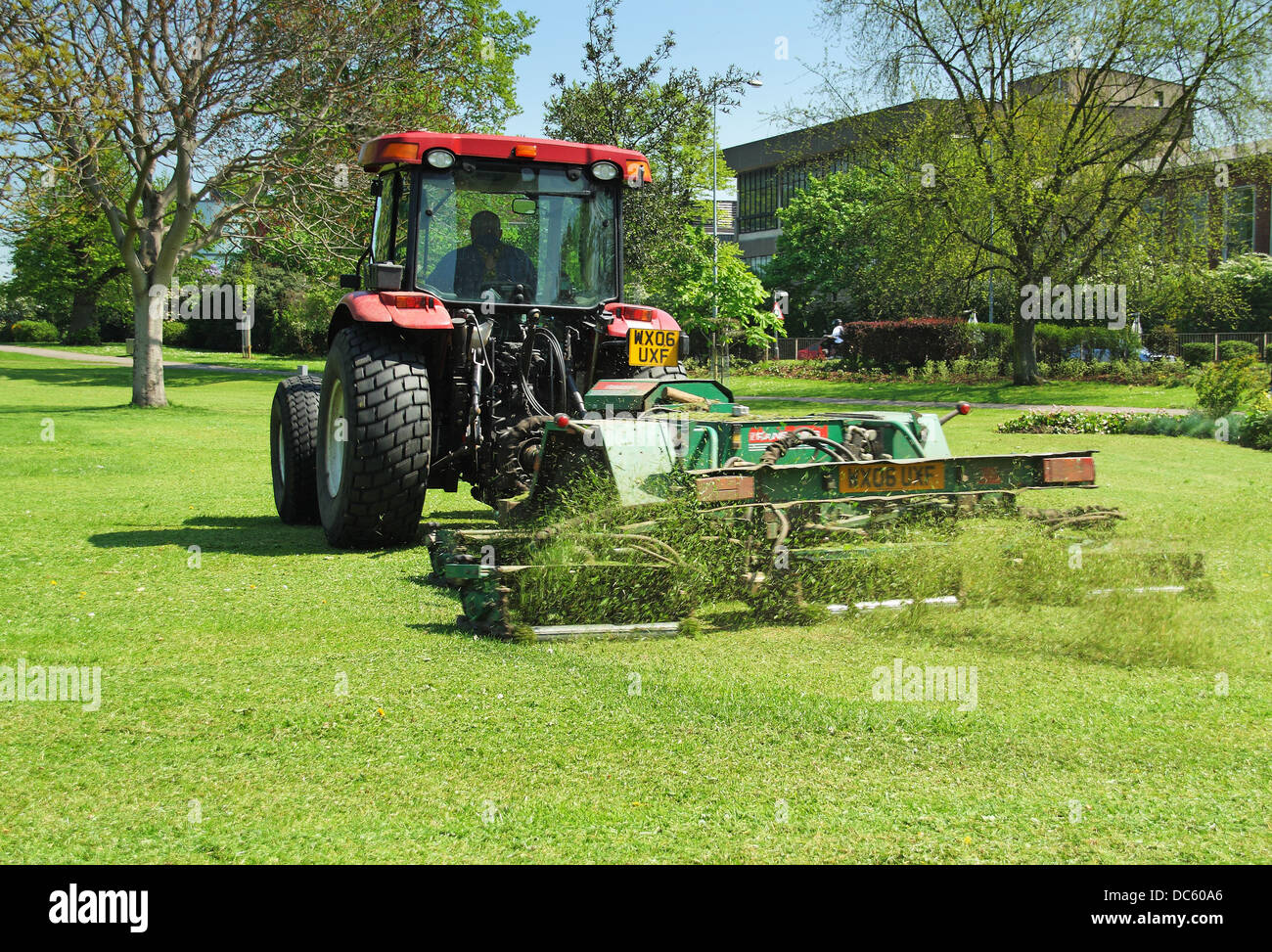Tractor mowing grass in a public park Stock Photo Alamy