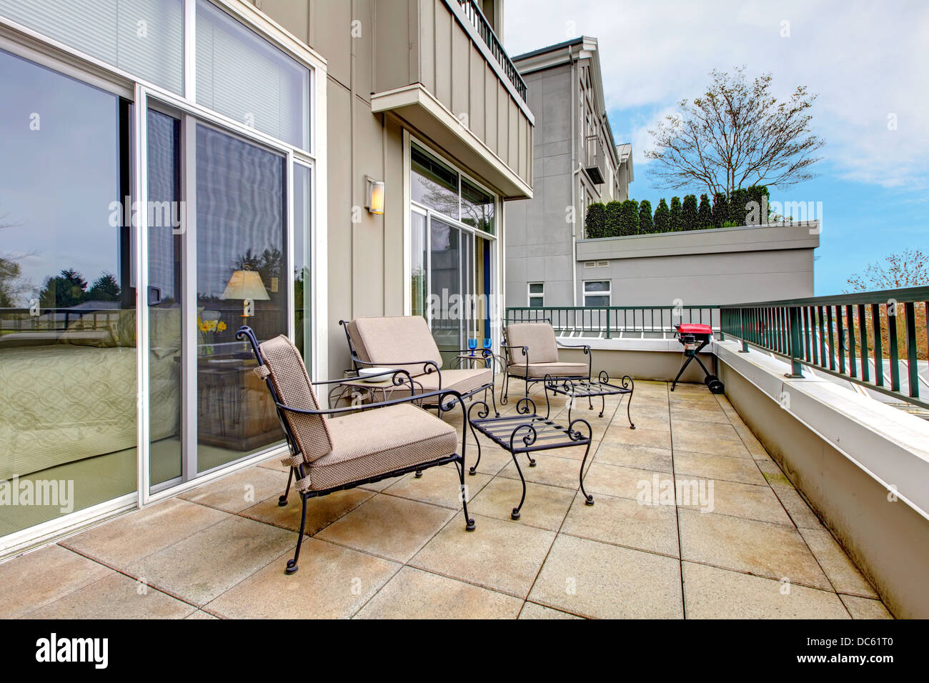 Balcony with furniture in new apartment building Stock Photo - Alamy