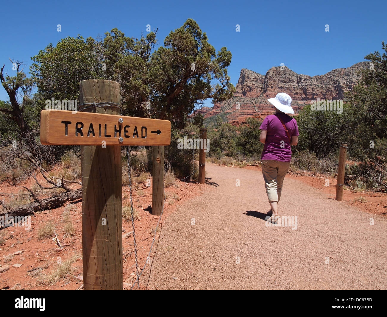 Woman tourist hikes back to the trailhead at Cathedral Rock, a magnetic (feminine) energy vortex, in Sedona, Arizona, USA Stock Photo