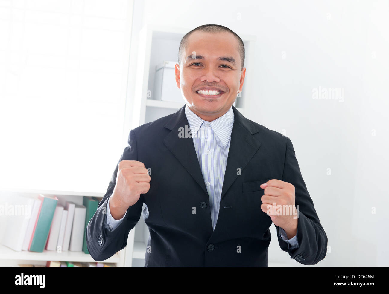 Excited Southeast Asian businessman Stock Photo - Alamy