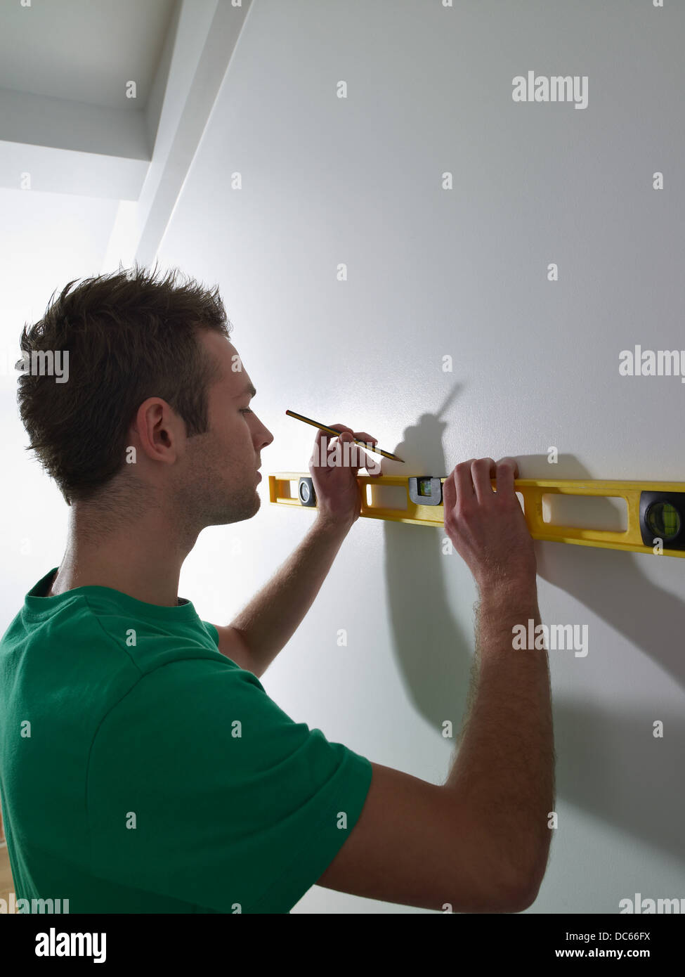 man measuring in new home Stock Photo