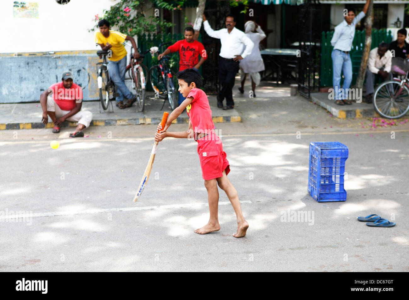 A young Indian boy shows great technique during a game of street cricket in Khajuraho, India. Stock Photo