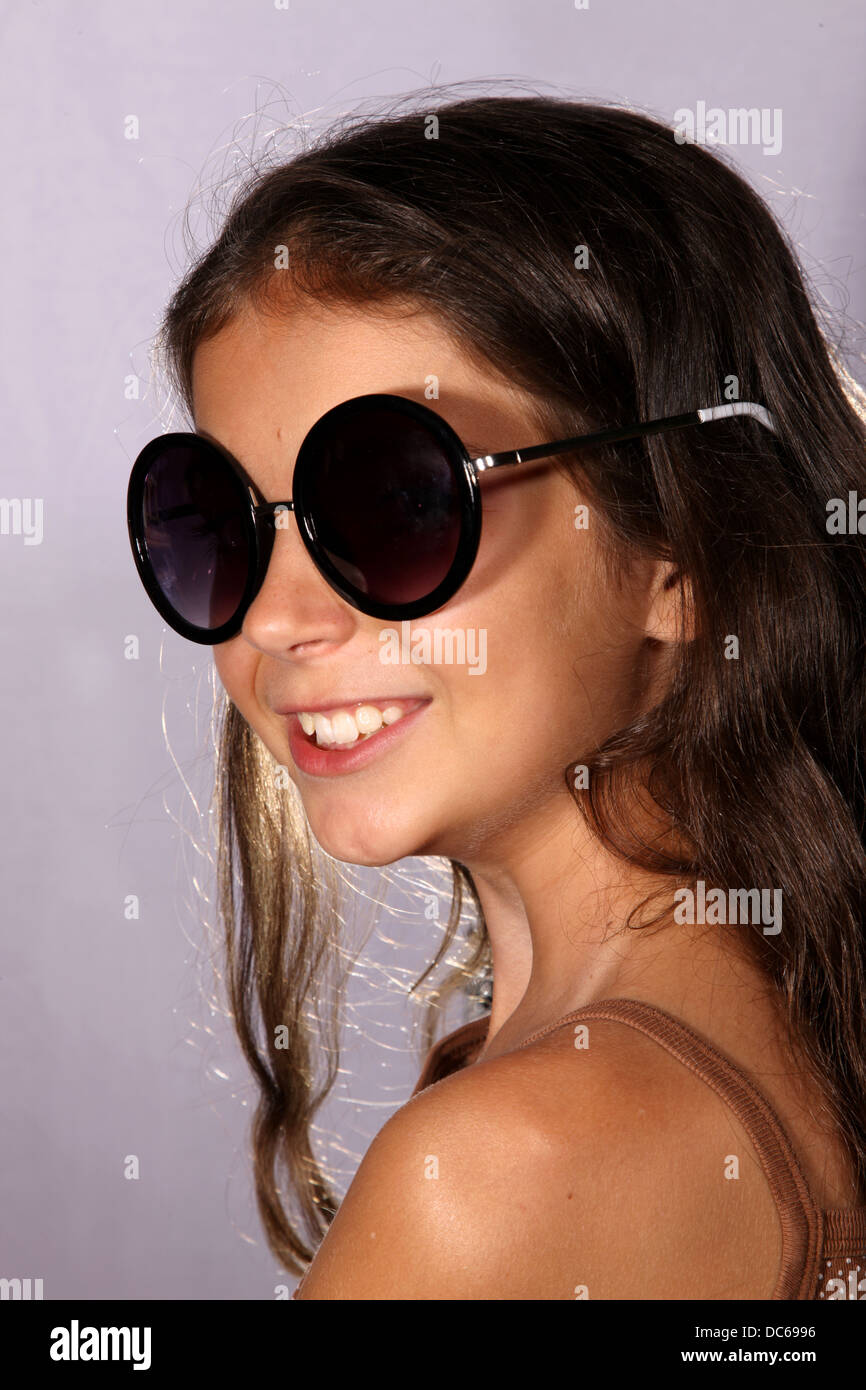 Young girl with sunglasses in studio lighting Stock Photo