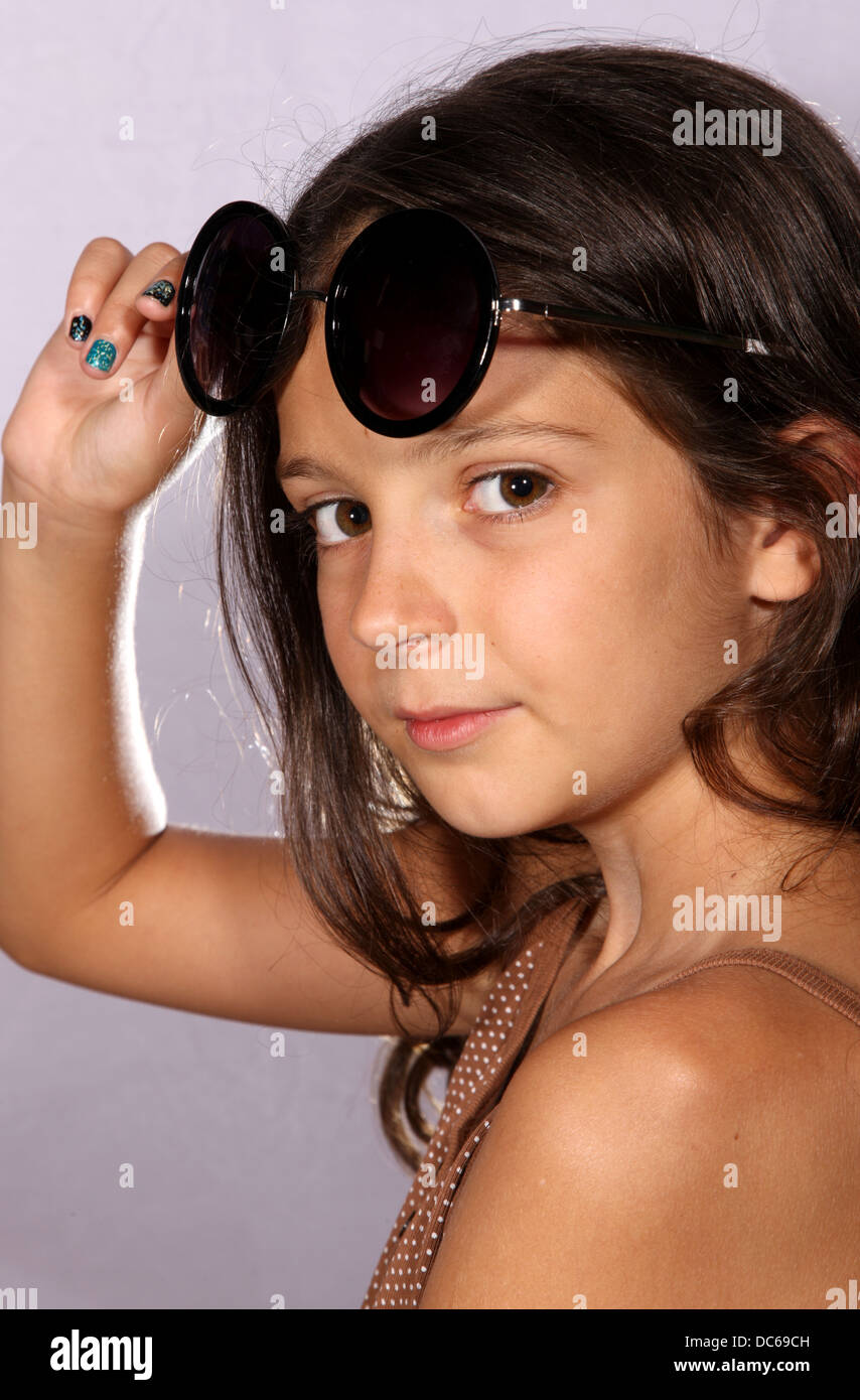 Young girl with sunglasses in studio lighting Stock Photo