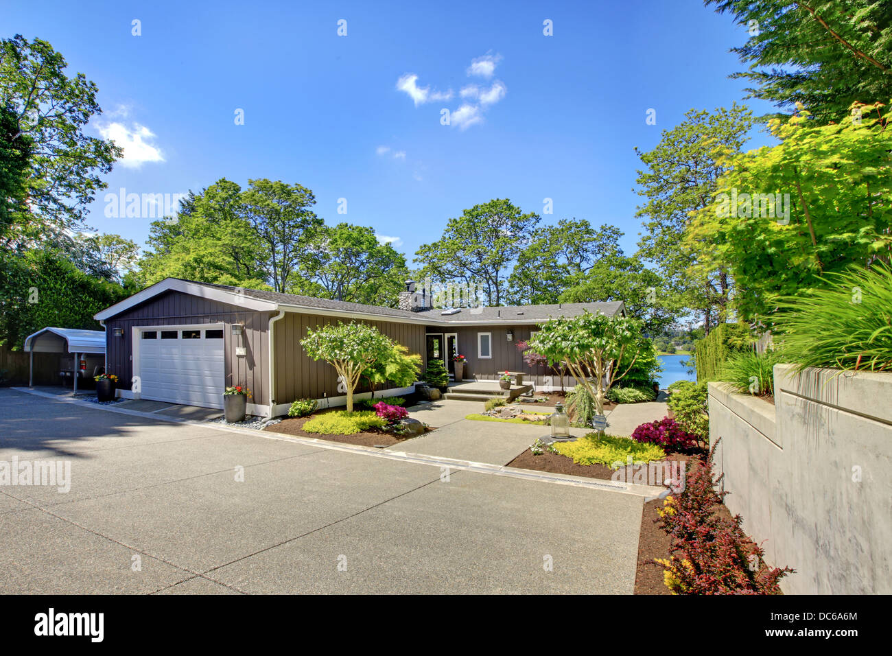 Beautiful home with garage, lake view and large front yard. Stock Photo