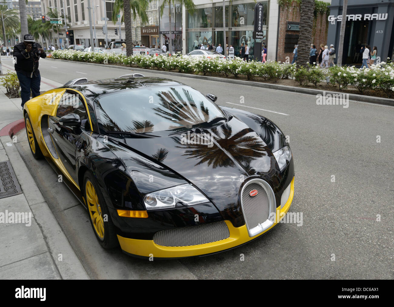 Bugatti Veyron with toursit taking picture, Rodeo Drive, Beverly Hills, CA Stock Photo