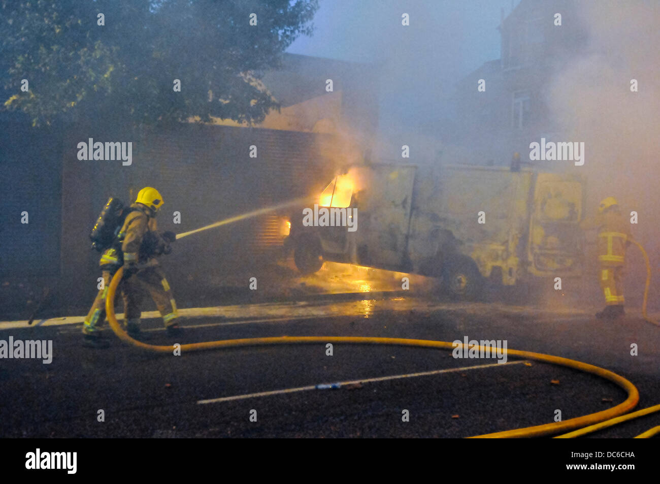 Belfast, Northern Ireland. 9th August 2013 - NIFRS extinguish a van set on fire during rioting Credit:  Stephen Barnes/Alamy Live News Stock Photo