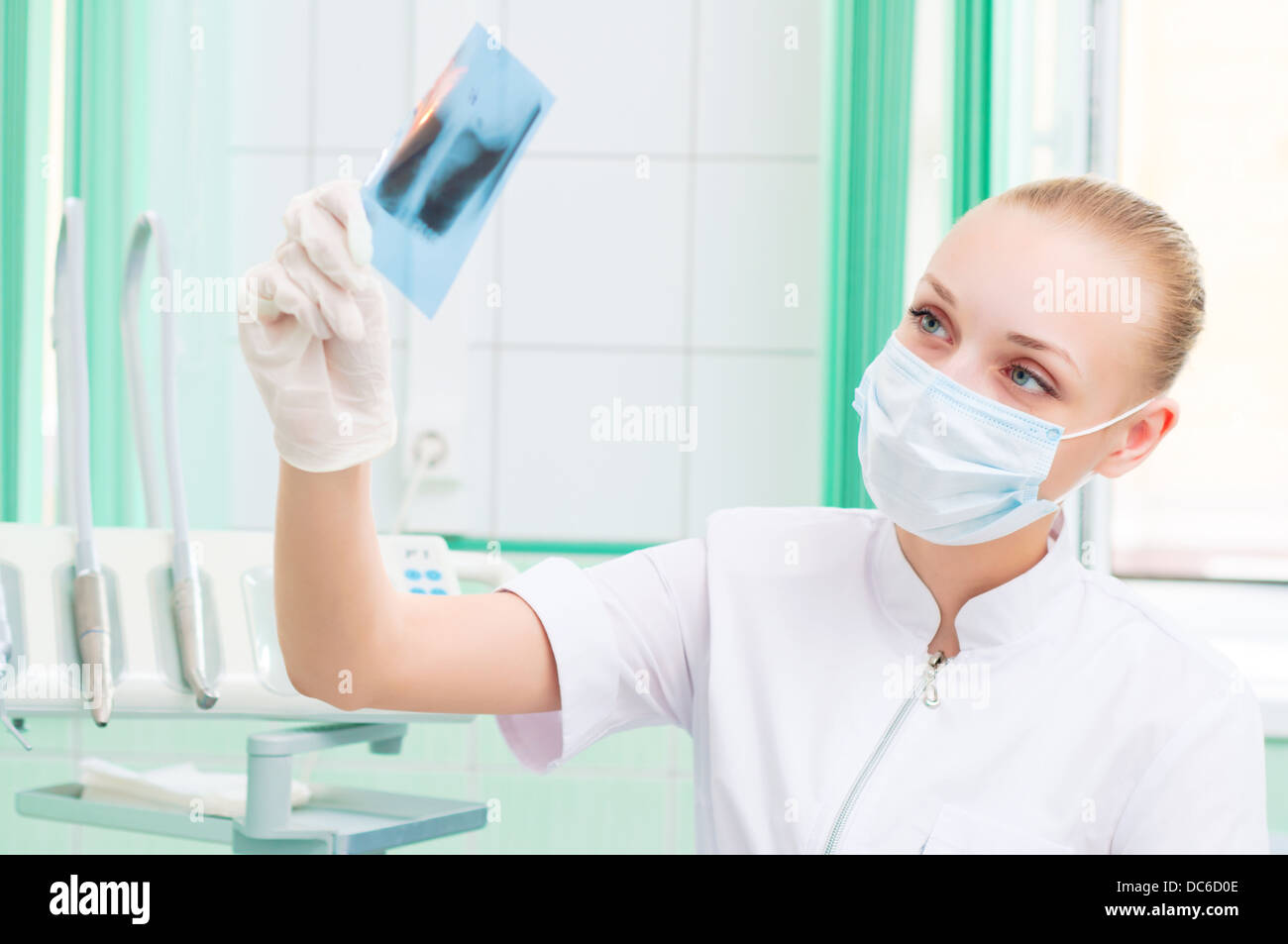 woman doctor in protective mask looking at x-ray Stock Photo