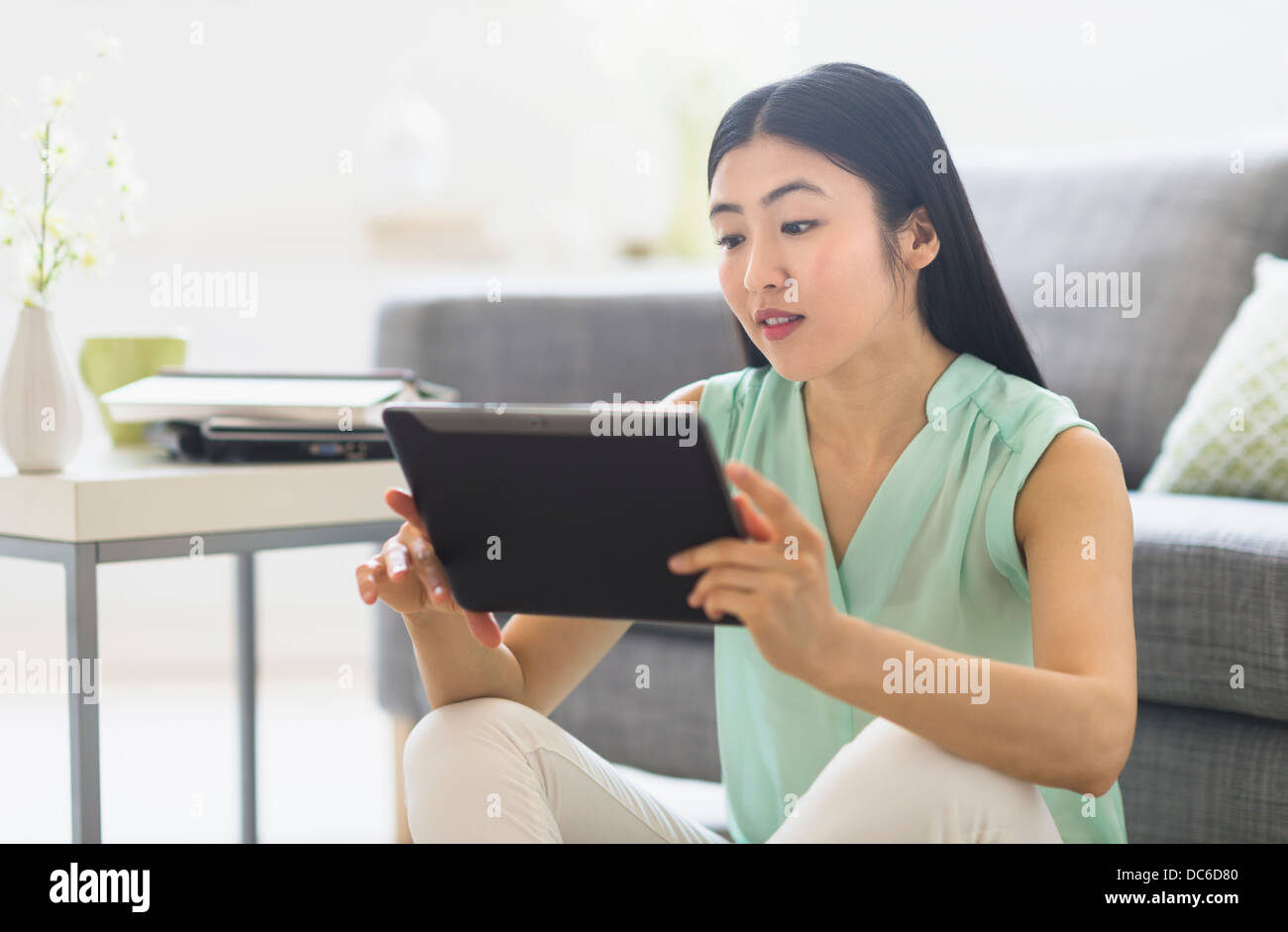 Woman using tablet pc at home Stock Photo
