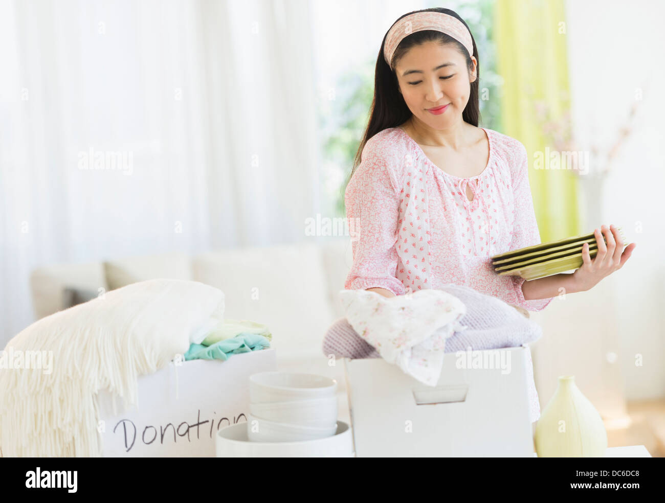 Woman donating household items Stock Photo