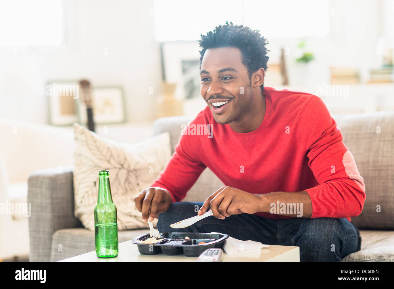 Man eating dinner and watching television Stock Photo Alamy